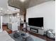 Bright open living room features hardwood floors, modern fireplace, and exposed concrete ceilings at 400 W West Peachtree Nw St, Atlanta, GA 30308