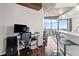 Living space with hardwood floors, office area, bar seating, and a large glass window at 400 W West Peachtree Nw St, Atlanta, GA 30308