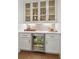 Well-appointed bar area with custom cabinets, a wine refrigerator, and stylish countertop at 1291 Briarwood Ne Rd, Brookhaven, GA 30319