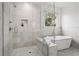 Modern bathroom with a glass enclosed shower, a soaking tub, and designer fixtures at 1291 Briarwood Ne Rd, Brookhaven, GA 30319