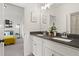 Bright bathroom featuring a double vanity with granite countertops and a glimpse into the cozy bedroom at 1291 Briarwood Ne Rd, Brookhaven, GA 30319