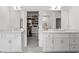 Elegant bathroom with double sink vanity, a dressing area, and access to a walk-in closet at 1291 Briarwood Ne Rd, Brookhaven, GA 30319