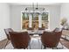 Bright dining room featuring a modern light fixture and large windows with a treelined view at 1291 Briarwood Ne Rd, Brookhaven, GA 30319
