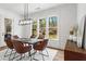 Dining room with a modern light fixture, shiplap walls, and a view of the backyard at 1291 Briarwood Ne Rd, Brookhaven, GA 30319