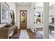 Inviting foyer with hardwood floors, wooden front door, stylish console table, and elegant decor creating a warm entrance at 1291 Briarwood Ne Rd, Brookhaven, GA 30319