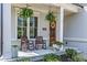 Inviting front porch with rocking chairs, hanging ferns, and a wood front door at 1291 Briarwood Ne Rd, Brookhaven, GA 30319