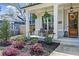 Charming front porch with rocking chairs, hanging ferns, and lush landscaping at 1291 Briarwood Ne Rd, Brookhaven, GA 30319