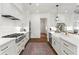 A modern kitchen with white cabinets, stainless appliances, lots of natural light and hardwood floors at 1291 Briarwood Ne Rd, Brookhaven, GA 30319