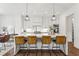 Modern kitchen with a large island, pendant lighting, stainless appliances, and hardwood floors at 1291 Briarwood Ne Rd, Brookhaven, GA 30319