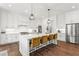 Bright kitchen features white cabinets, stainless steel appliances and a large island with seating at 1291 Briarwood Ne Rd, Brookhaven, GA 30319