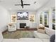 Comfortable living room with a fireplace, built-in shelving, and large windows providing ample natural light and a cozy ambiance at 1291 Briarwood Ne Rd, Brookhaven, GA 30319