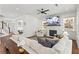 Spacious living room with a cozy fireplace, large TV, built-in shelving, and comfortable seating, perfect for relaxation at 1291 Briarwood Ne Rd, Brookhaven, GA 30319