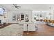 Bright open-concept living room featuring a cozy fireplace, large windows, and stylish decor leading to the dining area at 1291 Briarwood Ne Rd, Brookhaven, GA 30319