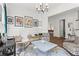 Elegant living room showcasing tasteful decor, unique art, comfortable seating, and seamless flow to adjoining spaces at 1291 Briarwood Ne Rd, Brookhaven, GA 30319