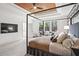 Bright main bedroom with exposed wood ceiling and a cozy sitting area overlooking the backyard at 1291 Briarwood Ne Rd, Brookhaven, GA 30319