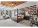 Spacious main bedroom with a striking accent wall, wood ceiling and ample natural light at 1291 Briarwood Ne Rd, Brookhaven, GA 30319