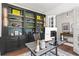 Well-lit home office boasts custom built-ins with shelves, cabinets, and a modern desk for a productive workspace at 1291 Briarwood Ne Rd, Brookhaven, GA 30319
