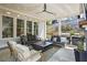 Inviting covered outdoor patio with comfortable seating, a ceiling fan, and a built-in grilling area at 1291 Briarwood Ne Rd, Brookhaven, GA 30319