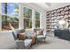 Charming sitting area with stylish chairs, modern art, and a view to the backyard at 1291 Briarwood Ne Rd, Brookhaven, GA 30319