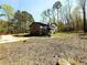 Two-story home with gray siding, a two-car garage, and a large yard surrounded by mature trees at 2919 Manitoba Ln, Marietta, GA 30062