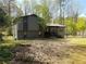 Two-story home with gray siding and a porch surrounded by mature trees and a large yard at 2919 Manitoba Ln, Marietta, GA 30062