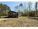 Two-story home with gray siding, a two-car garage, and a large yard surrounded by mature trees at 2919 Manitoba Ln, Marietta, GA 30062
