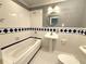 Bathroom featuring a bathtub and single sink vanity, complete with blue tiled accents at 2919 Manitoba Ln, Marietta, GA 30062