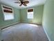 Bedroom featuring green walls, carpet, a ceiling fan, and two windows at 2919 Manitoba Ln, Marietta, GA 30062