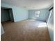 A spacious bedroom is lit by natural light from the window and sliding glass door at 2919 Manitoba Ln, Marietta, GA 30062