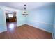 Bright dining room with hardwood floors, a vintage chandelier, and an open view to the kitchen at 2919 Manitoba Ln, Marietta, GA 30062