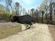 Two-story home with gray siding, a two-car garage, and a landscaped front yard surrounded by mature trees at 2919 Manitoba Ln, Marietta, GA 30062