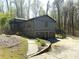 Two-story home with gray siding, a two-car garage, and a landscaped front yard surrounded by mature trees at 2919 Manitoba Ln, Marietta, GA 30062