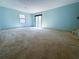 A spacious living room has carpet floors, natural light, and access to the backyard at 2919 Manitoba Ln, Marietta, GA 30062