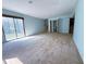 A spacious living room has carpet floors, natural light, and access to the stairs at 2919 Manitoba Ln, Marietta, GA 30062