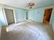 Main Bedroom featuring neutral walls, carpet, a ceiling fan, and doors to the closet and bathroom at 2919 Manitoba Ln, Marietta, GA 30062