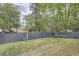 Backyard featuring a grassy lawn, wooden fence, and lush landscaping at 555 E Wesley Ne Rd, Atlanta, GA 30305