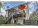Enjoy a backyard featuring a screened-in porch, spacious deck with an orange umbrella, and fenced-in yard at 555 E Wesley Ne Rd, Atlanta, GA 30305