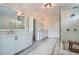 Bright bathroom with dual vanities, a glass shower, and neutral decor at 555 E Wesley Ne Rd, Atlanta, GA 30305