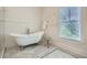 Bright bathroom featuring a clawfoot tub, marble floors, and classic fixtures at 555 E Wesley Ne Rd, Atlanta, GA 30305