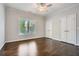 This bedroom features hardwood floors, a large window, and a closet with double doors at 555 E Wesley Ne Rd, Atlanta, GA 30305