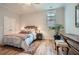 This bedroom features a stylish bed frame, a side table, and hardwood floors at 555 E Wesley Ne Rd, Atlanta, GA 30305