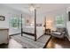This charming bedroom features a four poster bed, an accent rug, and two windows for ample light at 555 E Wesley Ne Rd, Atlanta, GA 30305