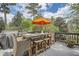 Outdoor deck featuring a dining table set and seating with an umbrella at 555 E Wesley Ne Rd, Atlanta, GA 30305
