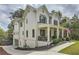 Side view of a two-story white home with brick foundation, black shutters, and well-manicured lawn at 555 E Wesley Ne Rd, Atlanta, GA 30305