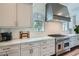 Close-up of kitchen area showcases stainless steel appliances, custom cabinets, and elegant marble countertops at 555 E Wesley Ne Rd, Atlanta, GA 30305