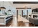 Open floor plan with kitchen island, hardwood floors, fireplace, and comfortable living room area at 555 E Wesley Ne Rd, Atlanta, GA 30305