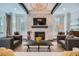 Stylish living room with stone fireplace, modern furnishings, and dark wood beams at 555 E Wesley Ne Rd, Atlanta, GA 30305