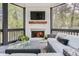 Cozy screened porch with fireplace, outdoor seating, and natural light at 555 E Wesley Ne Rd, Atlanta, GA 30305