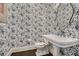 Stylish powder room features unique patterned wallpaper and a classic pedestal sink at 555 E Wesley Ne Rd, Atlanta, GA 30305
