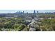 Expansive aerial view of the city with lush greenery and neighborhood streets under a blue sky at 737 Barnett Ne St # C4, Atlanta, GA 30306